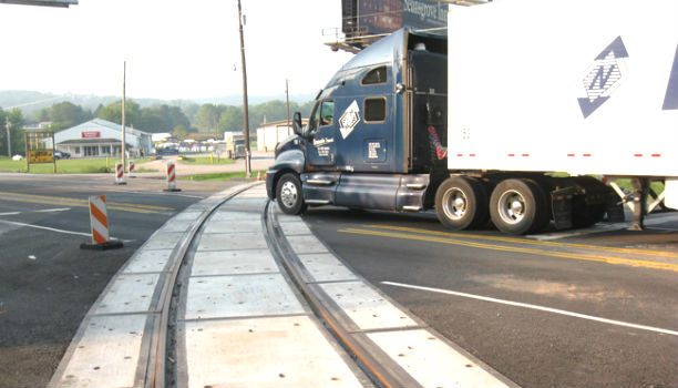 Tractor Trailer crossing railroad tracks on a highway