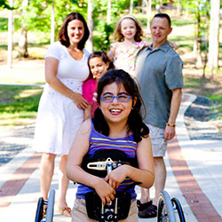 A young girl in front of her family