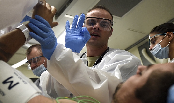 Air Force Capt. (Dr.) Kjell Ballard, emergency room resident, asks a patient to make the OK sign to check mobility of the fingers at the San Antonio Military Medical Center on Joint Base San Antonio-Fort Sam Houston, Texas. Serving 20 counties in the Texas region, the SAMMC Emergency Department treats roughly 200 patients a day. (U.S. Air Force photo by Staff Sgt. Kevin Iinuma)