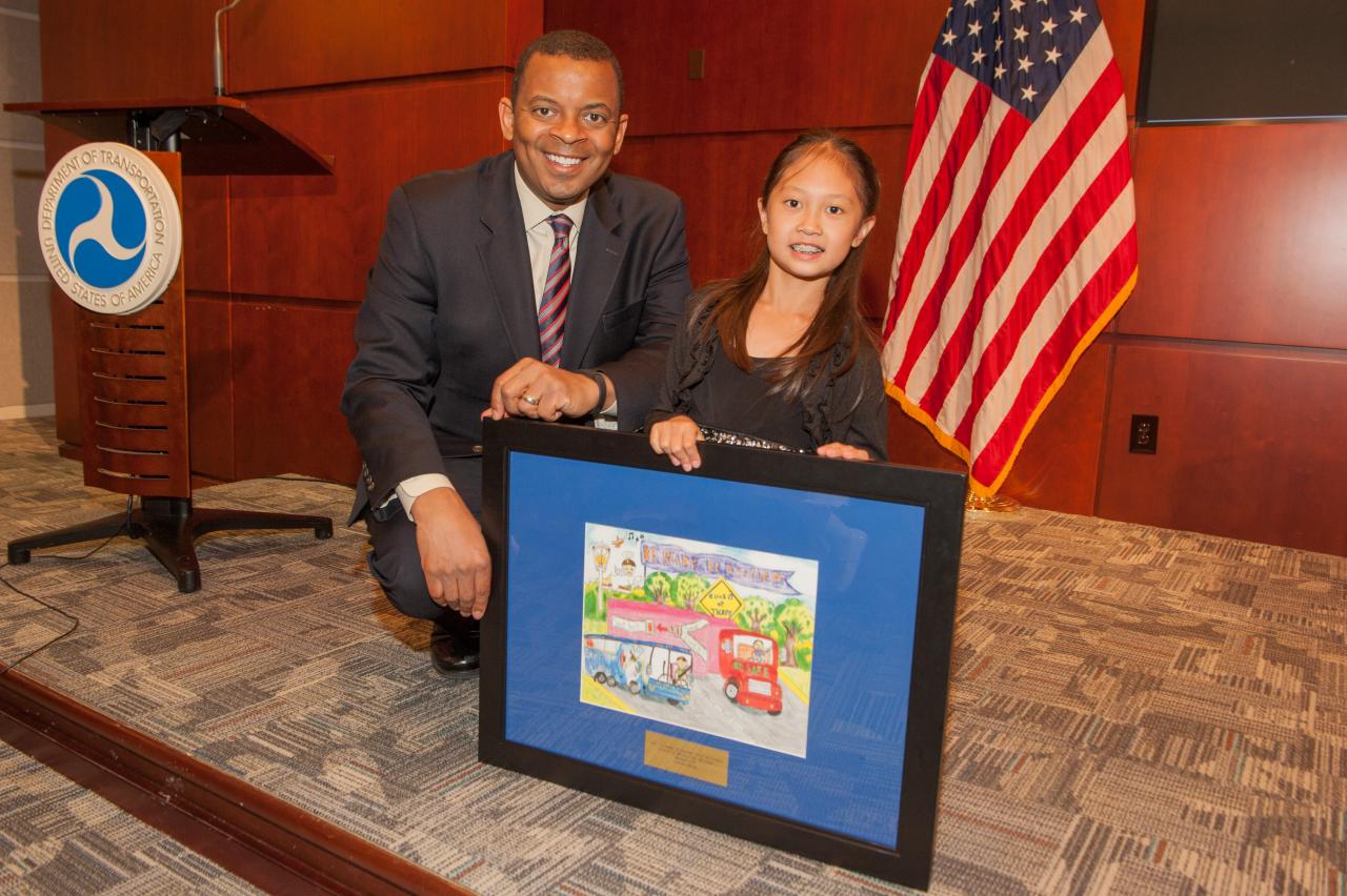 DOT Secretary Anthony Foxx with third-grader Heather Li of Orlando, Fla., who won top honors in the grades 3-6 category for the 2014 “Be Ready. Be Buckled.” student art contest.