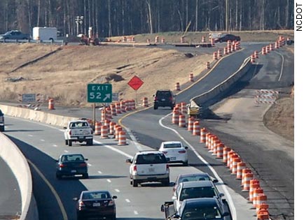 Currently, traffic on I–85 south is shifted to a new inside lane and median shoulder, while the original lanes are rebuilt on the outside. Traffic is using this temporary exit ramp until work on the diverging diamond interchange at Poplar Tent Road is completed.