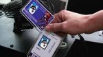 Close-cropped image of someone holding the University of Washington's student ID cards, the Husky card.