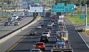 Photo. Dynamic lane control signs above a busy section of a Minnesota highway.  Example of an ATM strategy in use – dynamic lane use control in Minneapolis, MN.