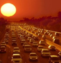 Photo of heavy traffic on a multi-lane road at sunset.