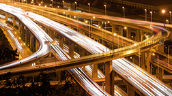 An image of highway overpasses at night. 