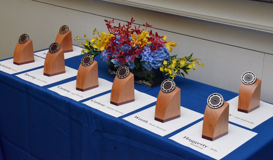 MTC Transportation Awards trophies sit on a table, each labelled with the name of the award presenter and winner.