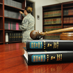 Service member looking for legal books in a library.