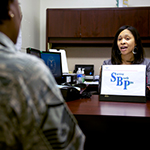 Service member talking with woman in office