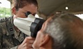Air Force Capt. Amanda Duty, 42nd Medical Group optometrist, uses a mobile auto refractor to examine the eyes of La Blanca resident Rolando Rojas during Exercise BEYOND THE HORIZON 2016 GUATEMALA. After Rojas’s eyes were examined, he was given a pair of prescription glasses to correct his vision. (U.S. Air Force photo by Senior Airman Dillon Davis)
