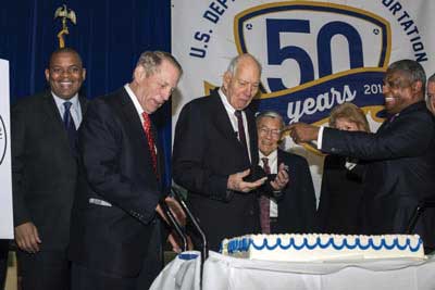 The kickoff event ended with the ceremonial cutting of an anniversary cake. Left to right, Secretary Foxx and former Secretaries Skinner, Boyd, Mineta, Peters (obscured), and Slater.