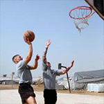 Service members playing basketball