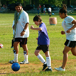 Group of kids playing soccer.