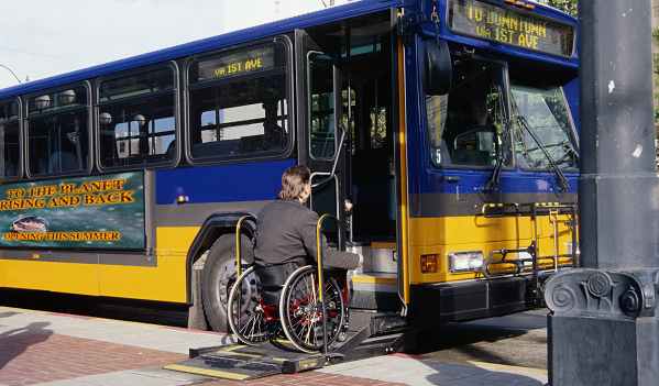 Man in wheelchair boarding a tranist bus