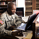 Picture of a service member using a computer