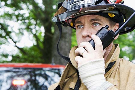 firefighter speaking into a radio