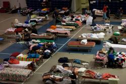 Red Cross shelter in an auditorium that is housing flood evacuees.