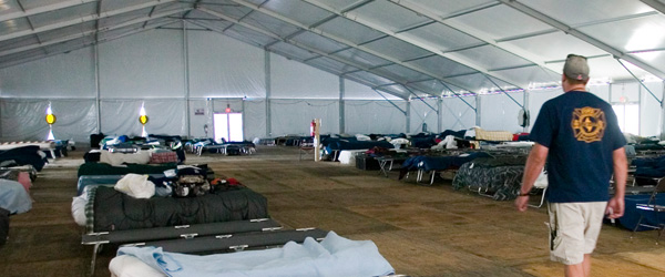 A mass care shelter with rows of cots