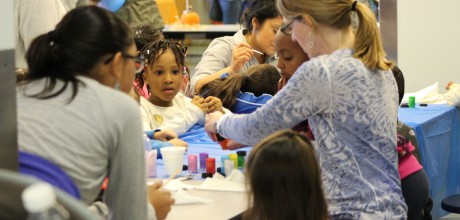 Caregiver doing art project with children.