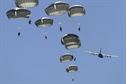 Paratroopers assigned to 1st Battalion (Airborne), 501st Infantry Regiment descend after jumping out of a C-130 Hercules, assigned to the 374th Wing from Yokota Air Base, Japan, over the Malemute drop zone at Joint Base Elmendorf-Richardson, Alaska, Aug. 24, 2015. Japanese Ground Self-Defense Force and Army paratroopers conducted the practice jump utilizing Royal Australian and U.S. Air Force aircraft as part of Pacific Airlift Rally 2015. The exercise is a biennial, multilateral tactical military symposium designed to enhance military airlift interoperability and cooperation between nations of the Pacific region for future humanitarian missions. (U.S. Air Force photo/Alejandro Pena)