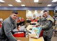 Senior Airman Logan Stack, from Detachment 2, 56th Operations Group, and Staff Sgt. Tylor Strop, assigned to the 173rd Fighter Wing, pick up Christmas gifts from the Arthur Street Senior Center to deliver to Meals on Wheels clients Dec. 16, 2015, at Klamath Falls, Ore. The 173rd FW has partnered with the Arthur Street Senior Center for over 15 years to distribute the holiday gifts collected by the center. (U.S. Air National Guard photo/Staff Sgt. Penny Snoozy) 

