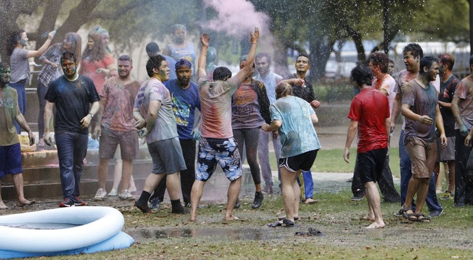 Students with colored powder in quad