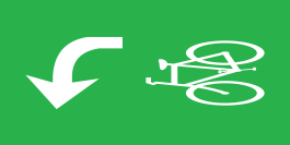 A green, horizontal  rectangle is shown.  The right-half of the rectangle has a white symbol of a bicycle oriented to bicycles approaching from the right.  The left-half of the rectangle has a white left turn arrow.