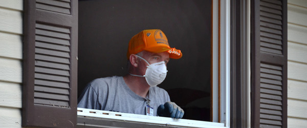 A man cleans his home after a disaster.