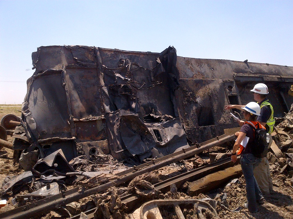 Mechanical engineer Karina Jacobsen and an NTSB investigator inspect train wreckage.