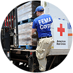 FEMA Corps member unloading cargo from Red Cross truck.