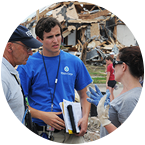 FEMA Corps member having conversation with debris in background