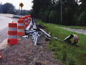 A damaged guard rail due to a car crashing into it.