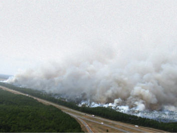 Photo of wildfire next to roadway in Texas