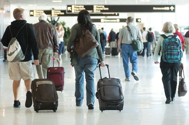 Photo of travelers moving through airport