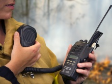 A firefighter using a handheld radio