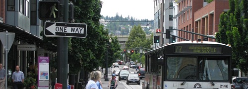 image of a street with cars and directional signage