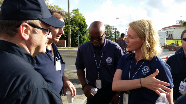 The Typhoon Dolphin FEMA leadership team discusses how best to support Guam and CMNI in assessing damages from Typhoon Dolphin. From left: Region 9 IMAT leader Kevin Cavanaugh, Region 9 Deputy IMAT leader Mark Armstrong, FEMA official Willie Nunn, and National IMAT leader Deanne Criswell. May 17, 2015.