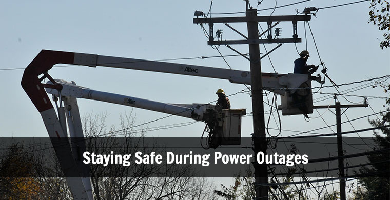 image of men in lifts working on power lines and the words Staying Safe During Power Outages