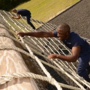 Recruit climbing the cargo net obstacle.