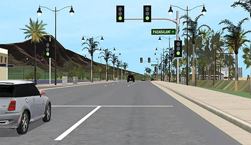 This  image shows an in-vehicle view of someone driving down a road toward Diamond  Head, Honolulu.  To the left and right  side are many trees. A large volcano is visible to the left. There is also a vehicle  nearby to the left and vehicles ahead in the distance.