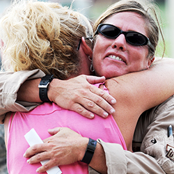 Female service member hugging a family member.