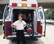 Female emergency official standing outside of ambulance