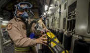 Photo: Air Force Tech. Sgt. Robert McNeal tests a portable oxygen tank before an aeromedical evacuation aboard a C-17 Globemaster III, at the 379th Air Expeditionary Wing in Southwest Asia, Dec. 9, 2013. (U.S. Air Force photo by Senior Airman Jared Trimarchi)