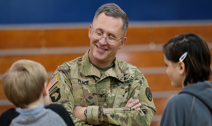 Army Col. Michael Place, commander of Madigan Army Medical Center at Joint Base Lewis-McChord, Washington, discusses school-based health with youngsters. (Courtesty photo )