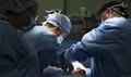 Army Capt. Gregory Lacy, 228th Combat Support Hospital urologist, (center), assists Army Col. George Newton, 228th CSH general surgeon, (right), while Army Spc. Marinel Armstead, 228th CSH surgical scrub technician, (left), observes during MEDEX. During the medical exercise, Soldiers integrated with Airmen to train for responding to potential real world contingency operations. (U.S. Air Force photo by Tech. Sgt. Araceli Alarcon)