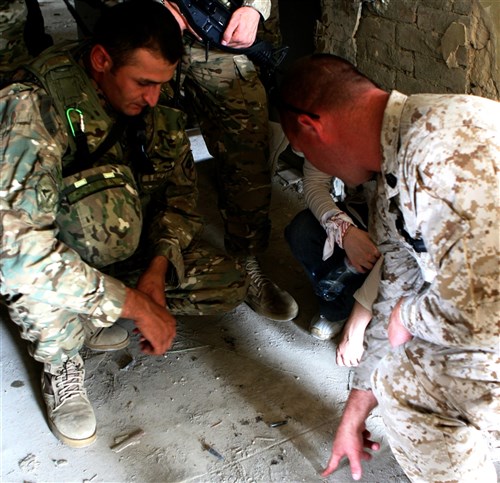 VAZIANI TRAINING AREA, Republic of Georgia-Gunnery Sgt. Charles Evers, an infantryman with Black Sea Rotational Force 11, draws a diagram on the floor for a Georgian soldier during Military Operations in an Urban Terrain training here July 19 as part of Exercise Agile Spirit 2011. Agile Spirit is designed to increase interoperability between the forces by exchanging and enhancing each otherrâ?s capacity in counterinsurgency and peacekeeping operations, including: small unit tactics, convoy operations, and counter-Improvised Explosive Device training. (Cpl. Nana Dannsaappiah)
