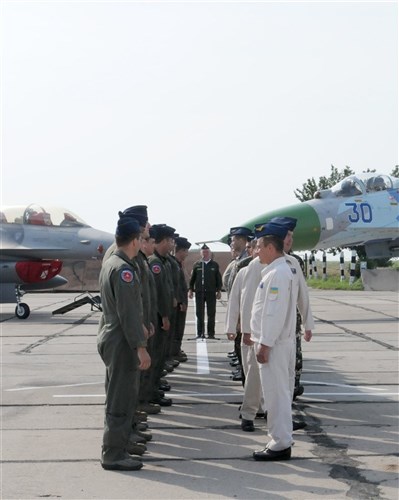 Pilots from the U.S.Air National Guard and Ukrainian air forces exchange greetings and well wishes at the conclusion of the opening ceremonies on July 18, 2011 at Mirgorod Air Base, Ukraine.  (U.S. Air Force By Tech. Sgt. Charles Vaughn, 144 FW/PA  /released) 