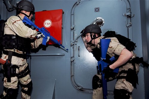 FGS WERRA, Baltic Sea – Logistics Specialist Seaman Jonathan Shackleford, left, and Gas Turbine Systems Technician (Mechanical) 3rd Class Matthew Norton prepare to open a hatch aboard the German FGS Werra (A 514), June 14, during a visit, board, search and seizure scenario in conjunction with the Baltic Operations (BALTOPS) 2012 exercise. BALTOPS 2012 is one of the largest, multi-national maritime training exercises held in the Baltic region this year and is intended to improve interoperability with partner nations by conducting realistic training both on land and at sea. 
