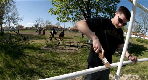 Second Lt. Bryan Humphries, 31st Maintenance Squadron, cleans playground equipment at a park in Graf Ignatievo, Bulgaria April 22, 2012. More than 150 U.S. and Bulgarian air force members volunteered their off-duty time to refurbish playground equipment and build a soccer field at a village park. U.S. Air Force members are deployed from the 31st Fighter Wing at Aviano Air Base, Italy, to Graf Ignatievo Air Force Base to participate in Thracian Star 2012, a coalition training exercise geared towards strengthening partnerships and improving interoperability between NATO allies. 