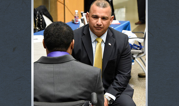 Mr. James Rodriguez, deputy assistant secretary of defense, Office of Warrior Care Policy, meets with a service member during an Operation Warfighter internship fair. Operation Warfighter is a Department of Defense internship program that matches qualified wounded, ill and injured service members with federal internship opportunities during their recovery and rehabilitation.