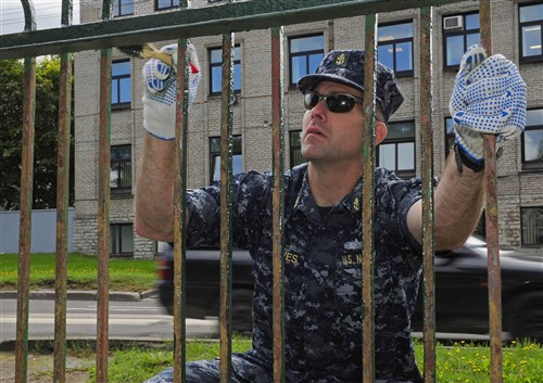 TALLINN, Estonia – Chief Electronics Technician Jason Howes, from the guided-missile destroyer USS Farragut (DDG 99), paints a fence at the Tondi School for Special Needs Children in Tallinn during a community service project. Farragut is on a scheduled deployment in support of maritime security operations and theater security cooperation efforts in the U.S. 6th Fleet area of responsibility.